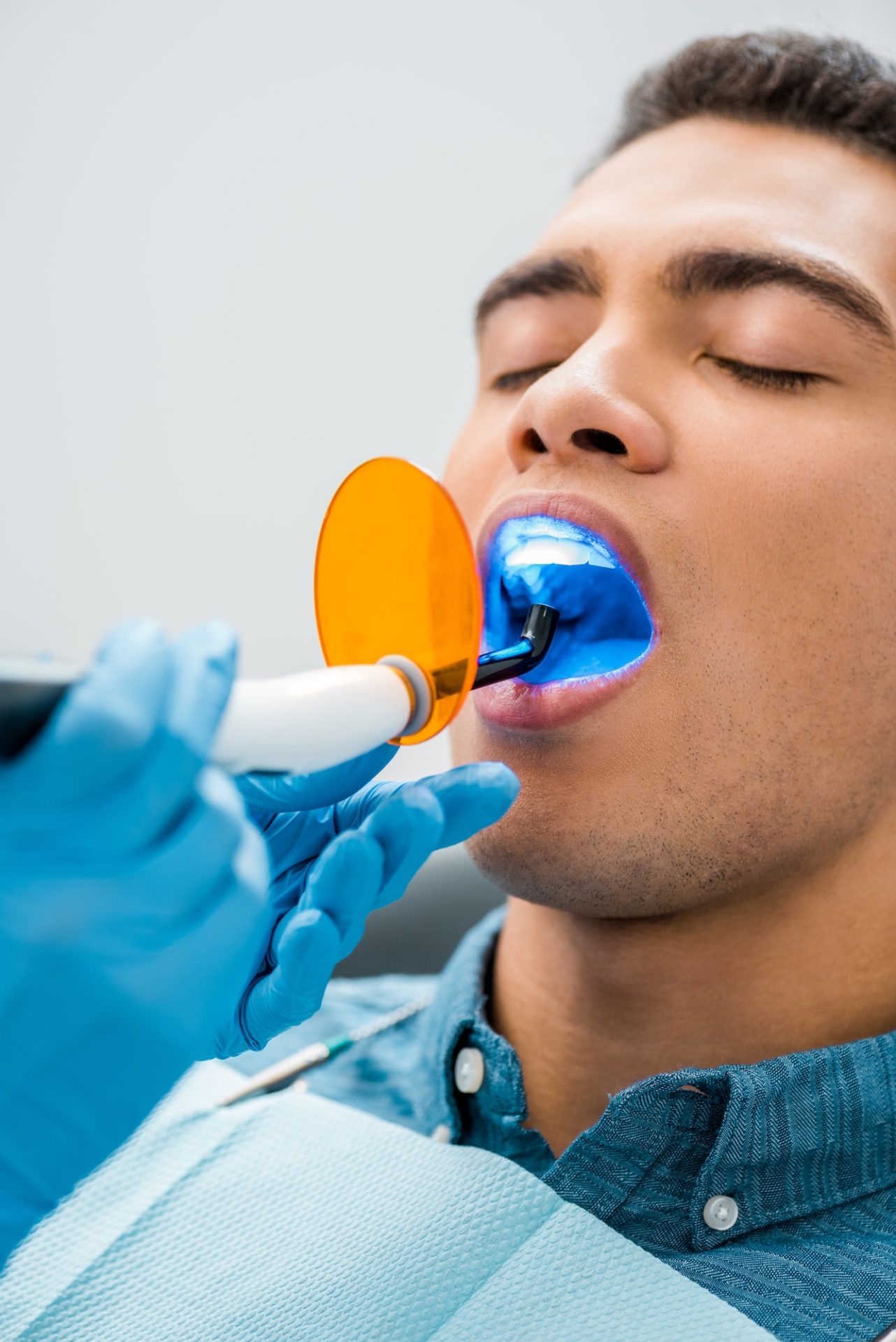 close up of handsome african american man during whitening procedure